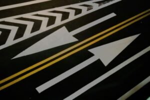 Various traffic sign shapes including stop, yield, warning, and regulatory signs mounted on roadside or trailer systems